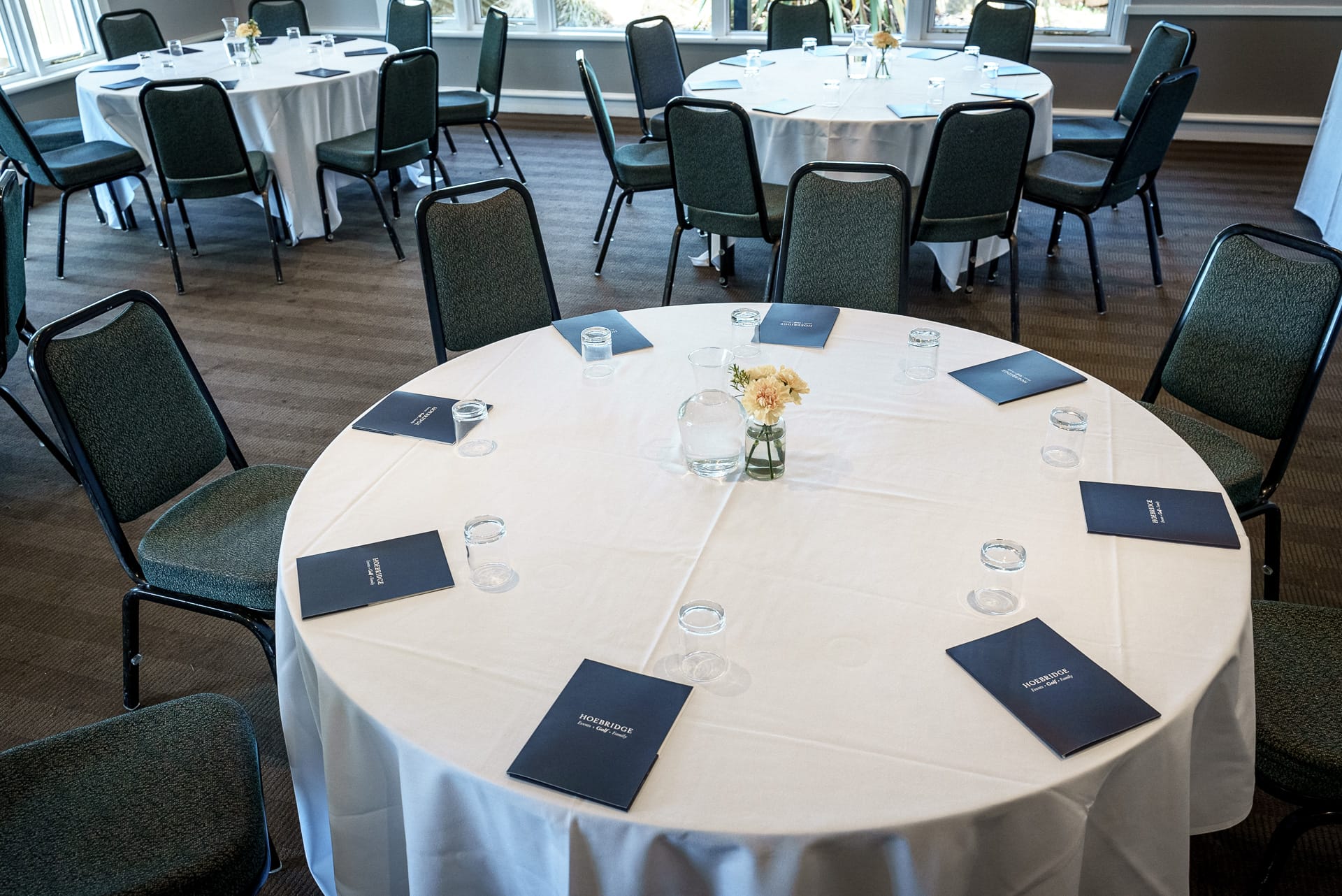 meeting room arranged with personalised notepads at a conference venue in woking
