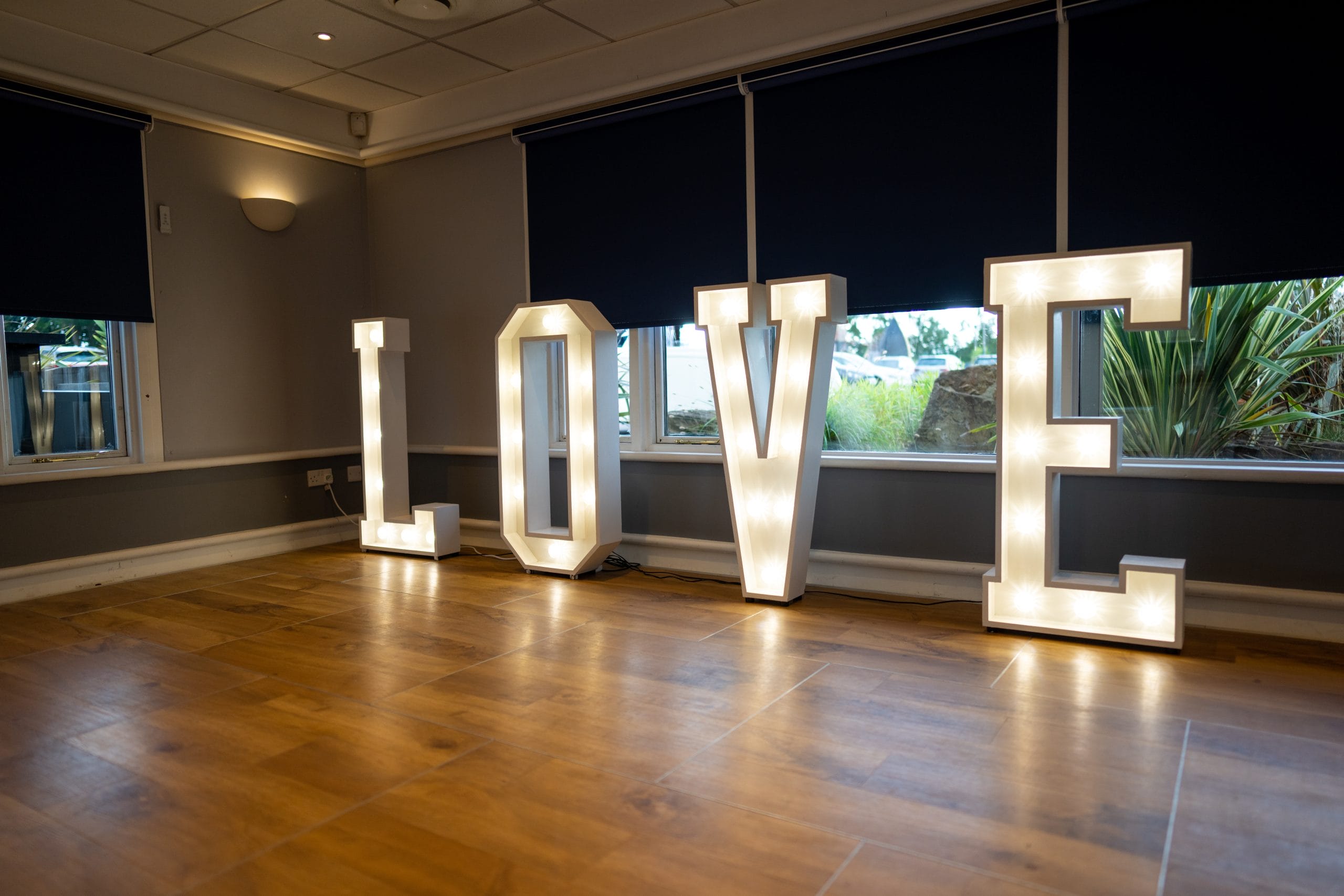 Decorative LOVE sign displayed at a wedding venue in Surrey, perfect for romantic photo backdrops and wedding receptions in Surrey decor
