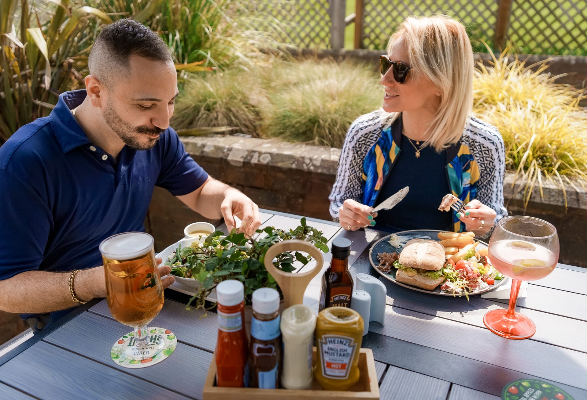 couple enjoying delicious food in woking outside on a terrace