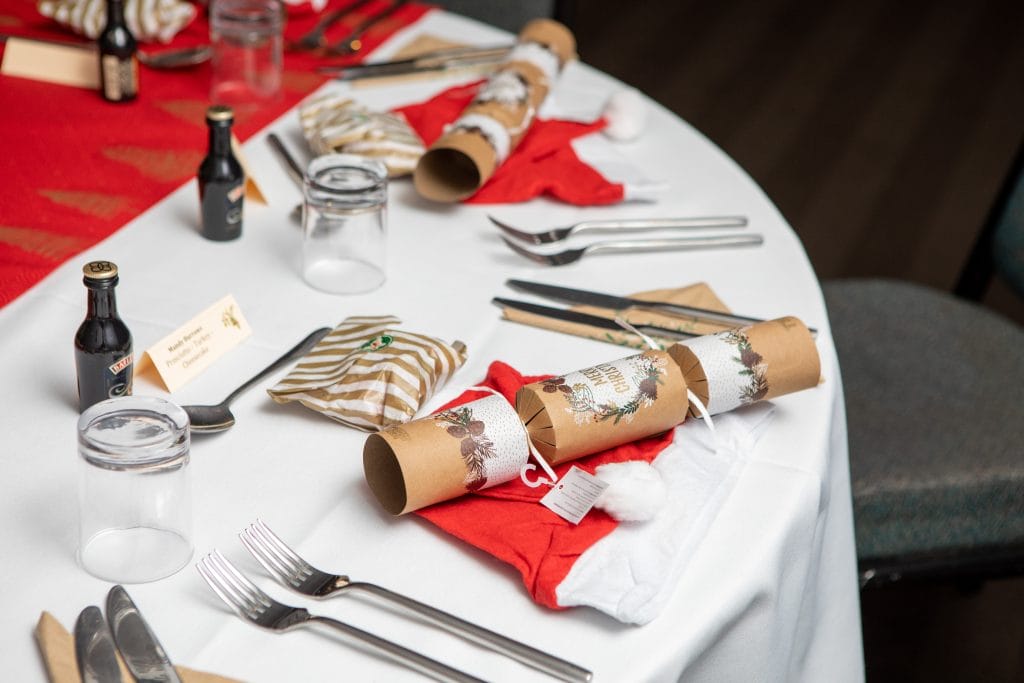 christmas crackers decorated on tables at a christmas party in woking