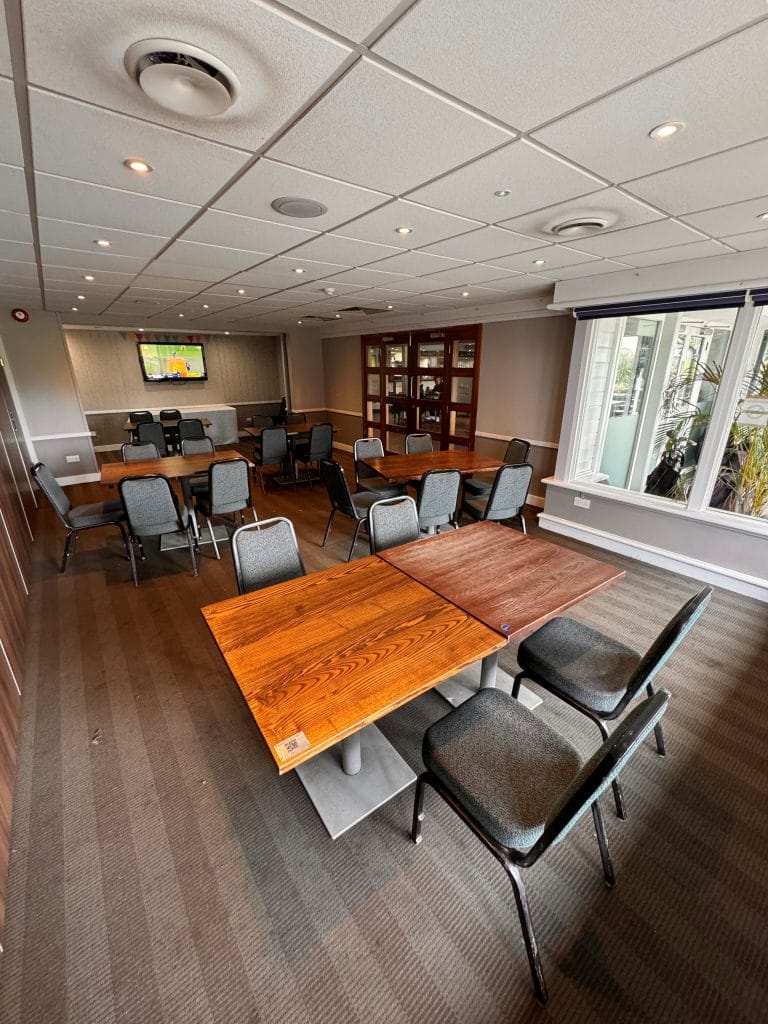 conference venue in woking with chairs and tables arranged towards a TV