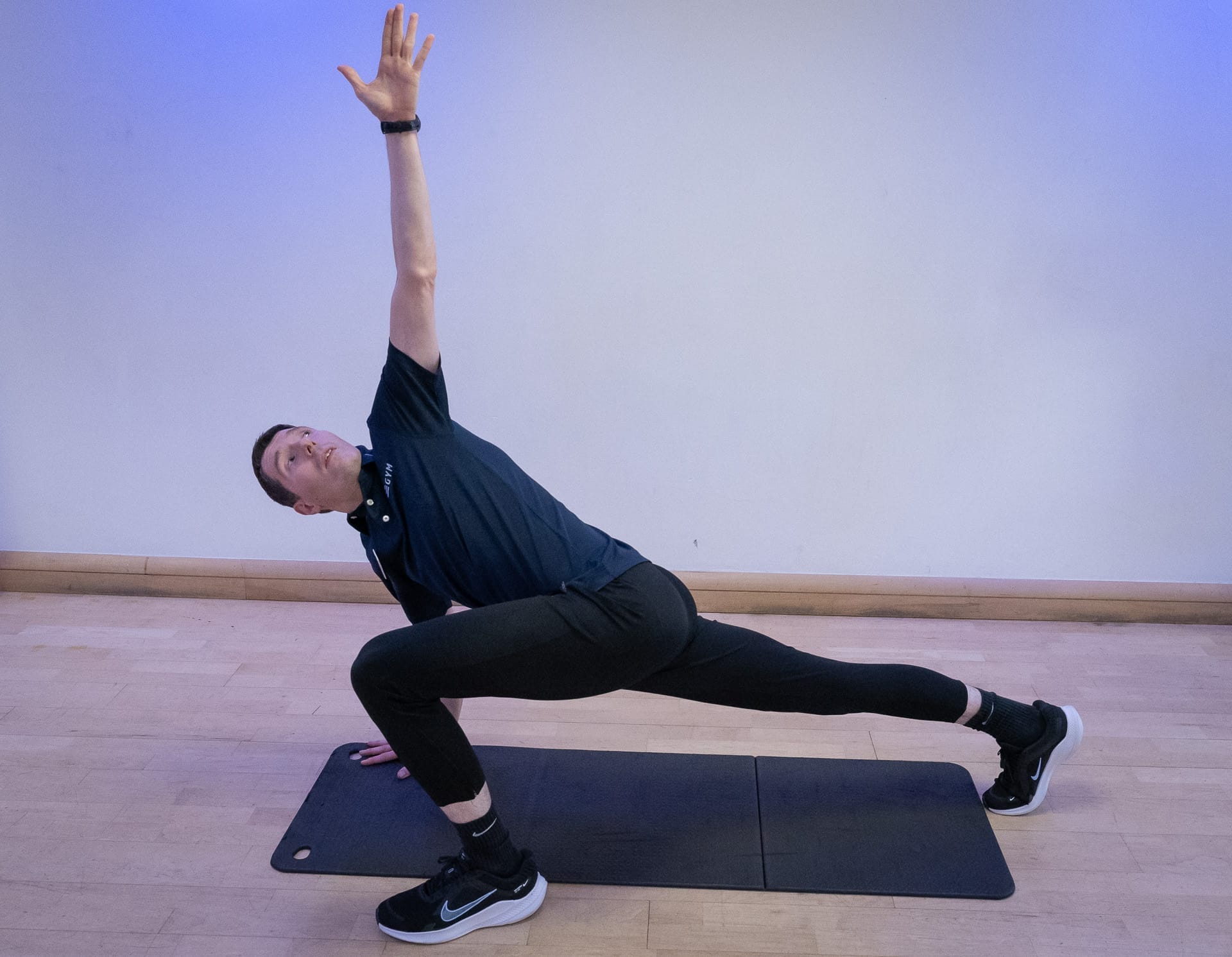 man stretching on mat at gym near guildford